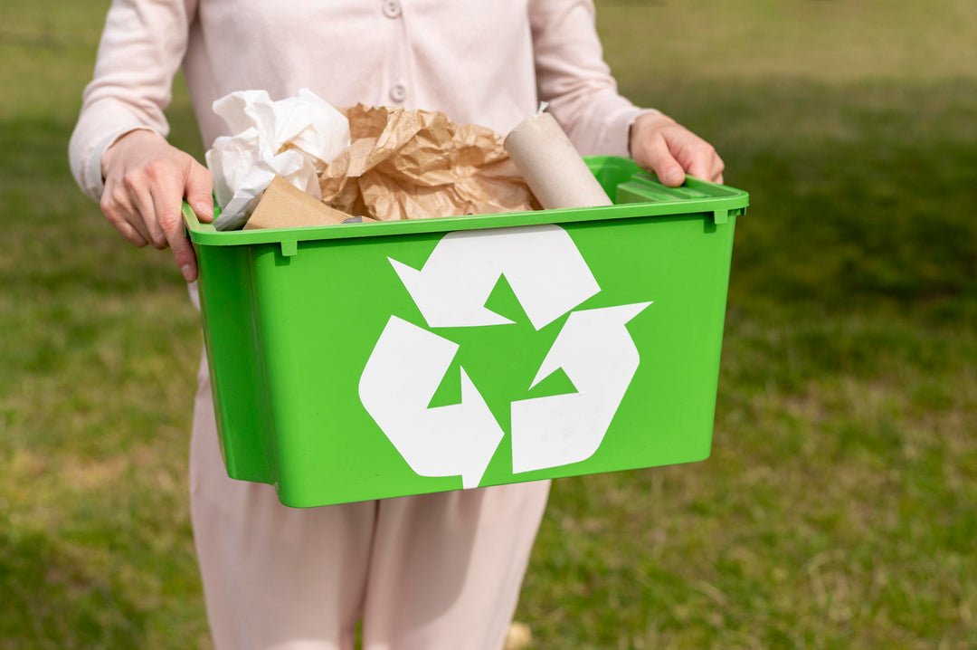 woman holding a recycling box with cardboard and paper inside of it